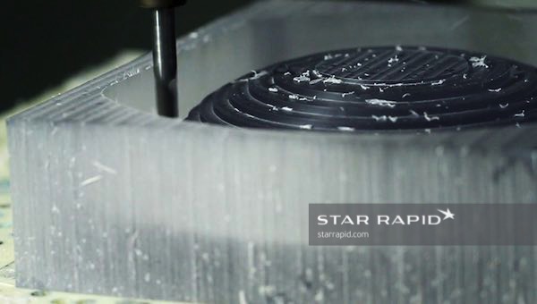 An acrylic block being milled into a lens blank at Star Rapid