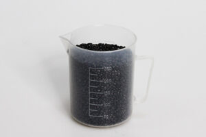 Beaker of plastic masterbatch pellets for injection molding at Star Rapid