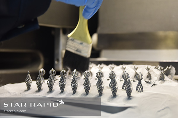 Brushing Ti powder away from 3D printed jewelry