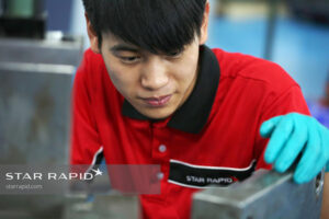 Star Rapid technician checks a plastic injection mold tool before installation.