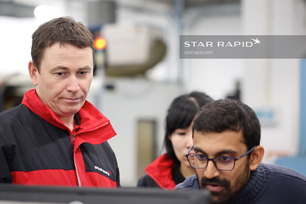 A team of technicians at Star Rapid discuss 3D printing.