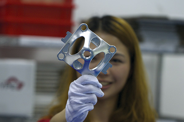 Star Rapid operator with a sample machined part